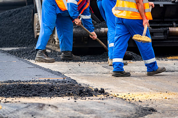 istock The workers and the asphalting machines 607776156