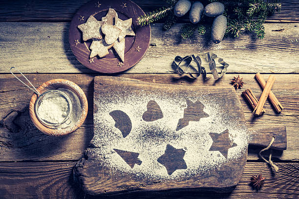 istock Decorating with icing sugar Christmas gingerbread cookies on wooden table 607776910
