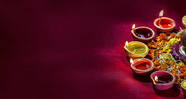 Clay diya lamps lit during Diwali Celebration. Greetings Card Design Clay diya lamps lit during Diwali Celebration. Greetings Card Design Indian Hindu Light Festival called Diwali goddess photos stock pictures, royalty-free photos & images