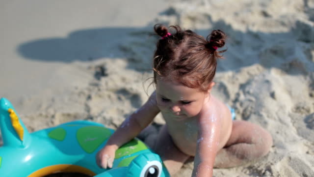 baby playing on the beach