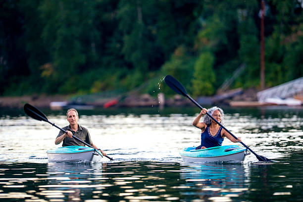 istock Elderly heterosexual diverse couple paddling their kayaks 607873320
