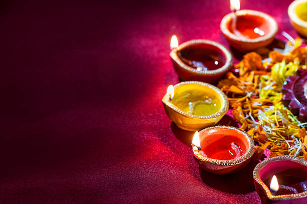 istock Clay diya lamps lit during Diwali Celebration. Greetings Card Design 607873580
