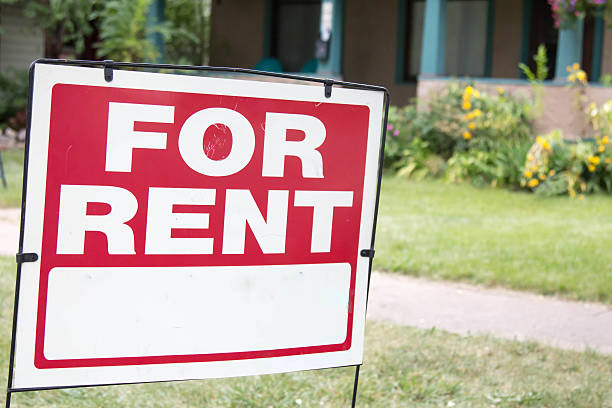 istock Paper blank for rent sign in front of a home 607877802