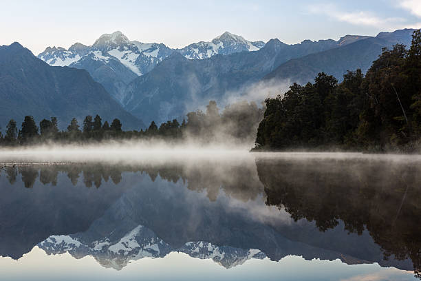 Lake Matheson Nature Panorama at Sunrise, New Zealand Lake Matheson Nature Panorama at Sunrise, New Zealand, South Island fox glacier photos stock pictures, royalty-free photos & images