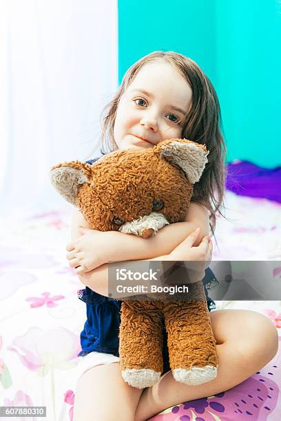 Adorable Little Girl Holding Vintage Teddy Bear In Bedroom Usa Stock Photo - Download Image Now