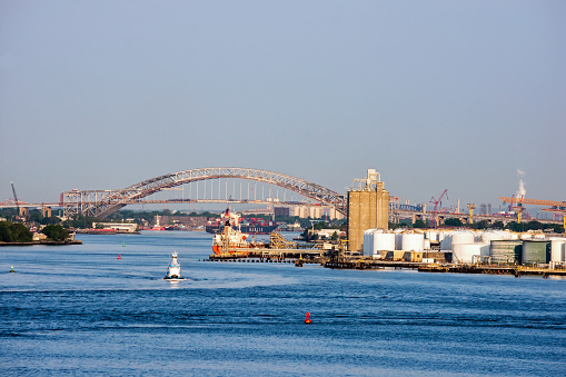 Bayonne, NJ USA - May 29, 2016: A view of the Bayonne Bridge renovation progress from the Hudson Bay in New Jersey. 