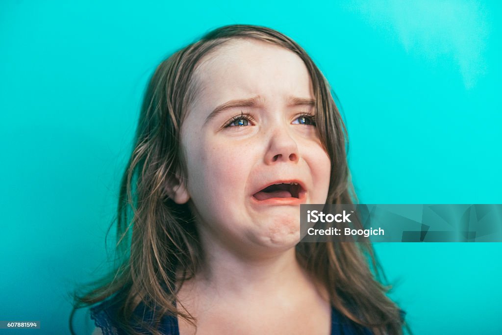 Upset Little Girl Having a Temper Tantrum Screaming and Crying This is a horizontal, color photograph of an adorable four year old, little girl screaming and crying as she has a temper tantrum. Photographed with a Nikon D800 DSLR camera. Child Stock Photo