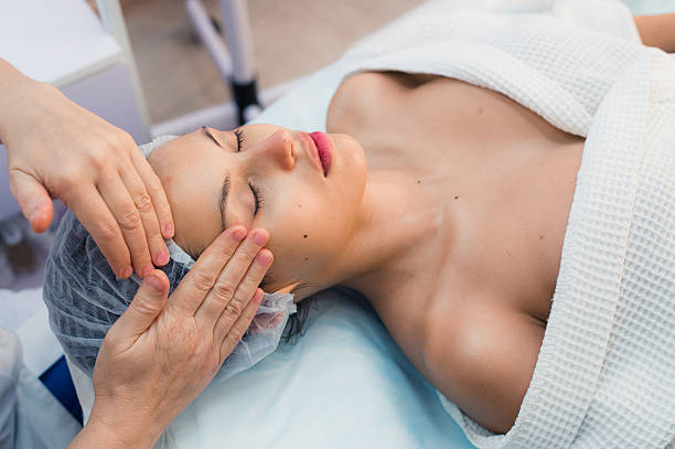 istock Smiling brunette enjoying a head massage in the health spa 607882132