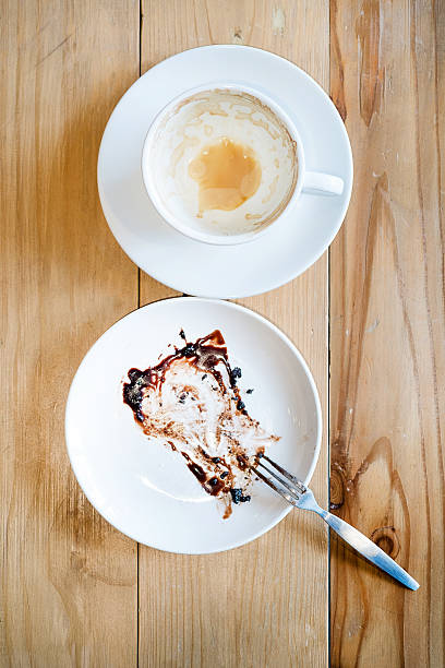 empty coffee cup and dessert after drink on wooden table