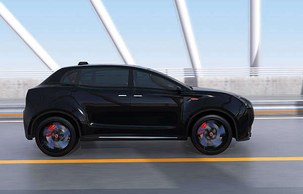 istock Black electric SUV driving on arc bridge 607883480