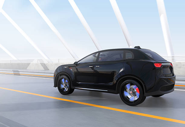 istock Black electric SUV driving on arc bridge 607883584