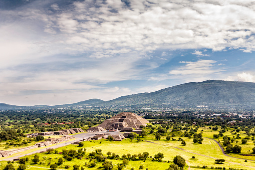 Pre-Hispanic City of Teotihuacan. Mexico. The holy city of Teotihuacan is situated about 30 miles (50 kilometers) northeast of Mexico City. No one knows who did it but it was built aprox 2,100 years ago. The main and largest monuments are the Temple of Quetzalcoatl and the Pyramids of the Sun and the Moon. Those monuments were laid out on geometric and symbolic principles.  The name of Teotihuacan was given to it by the Aztecs and means “the place where the gods were created.”