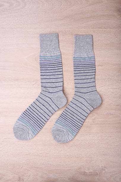 istock New socks on wooden background 607886262