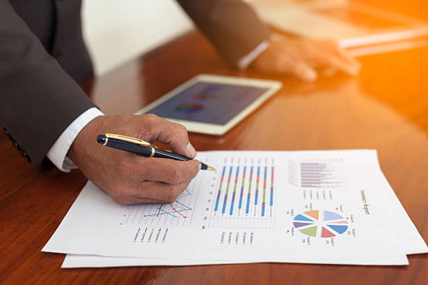 istock hand of business man working document 607887446