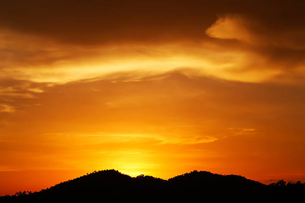 istock sunset over the mountain hills 607887656