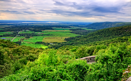 View of rolling green hills, farm land and Ottawa River from Gatineau Park, a provincial park of Quebec, Canada
