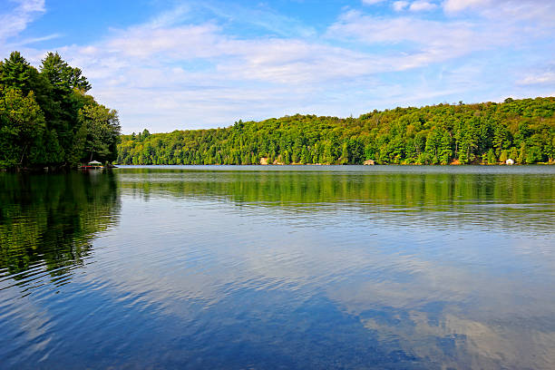 Cottages along the tranquil water of Meech Lake, Gatineau Park, a provincial park in Quebec, Canada