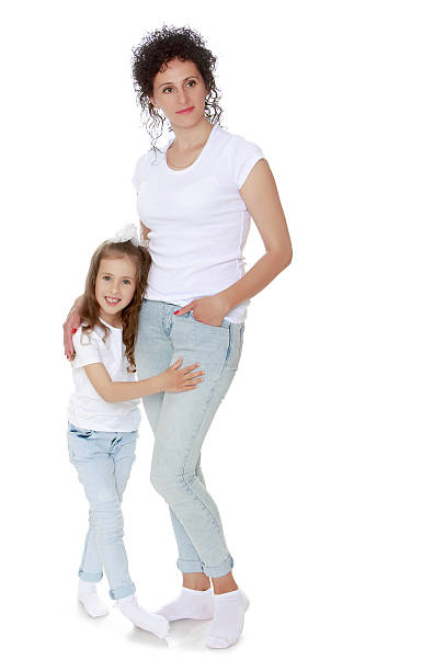 istock Mom and daughter in jeans  white shirts 607890802