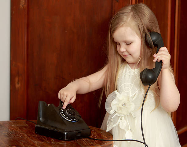 istock Girl with vintage phone 607892062