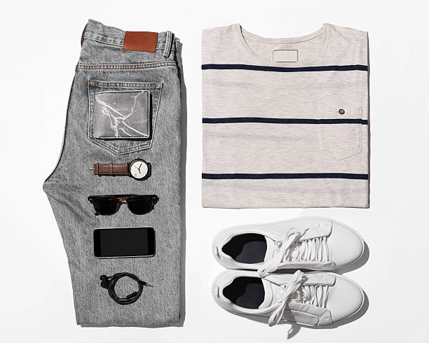 Overhead view of men's casual outfits, Outfits of traveler, male Man's clothing ( T-shirt,jean,wallet,watch,sunglasses,phone,earphone shoe.) flat shoe photos stock pictures, royalty-free photos & images