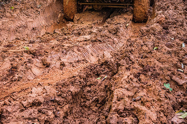 istock Tire tracks on a muddy road. 607893714