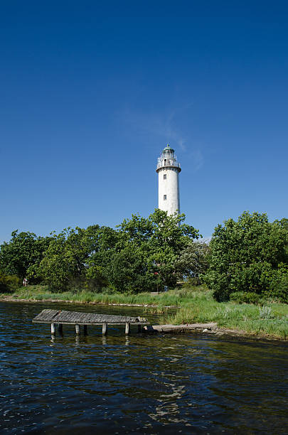 istock Lighthouse and an old wooden pier 607893882