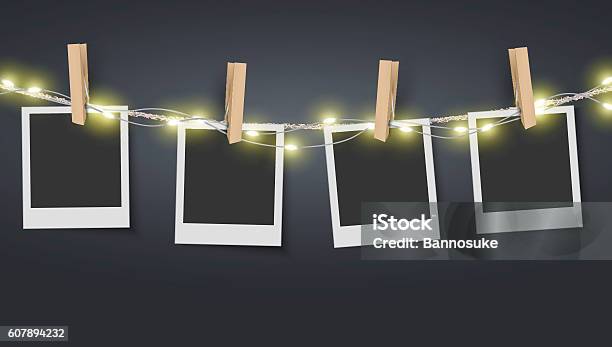 Blank Photo Frame Hanging On Rope With Fairy Lights Stock Illustration - Download Image Now