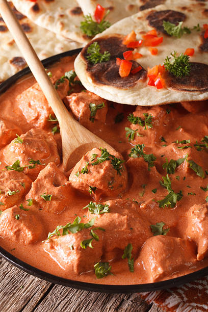 istock Indian food chicken tikka masala macro on a plate. Vertical 607894358