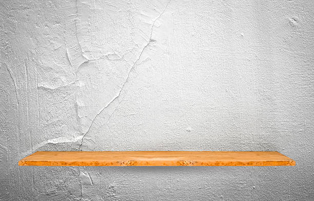 istock Wooden shelf on concrete wall background. 607894512