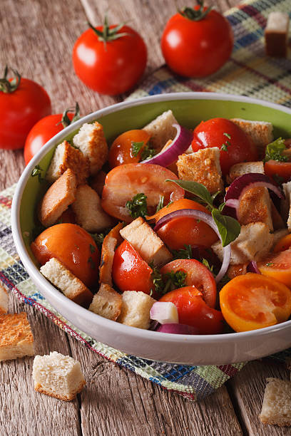 istock Italian bread salad - panzanella close-up on the table. Vertical 607894602