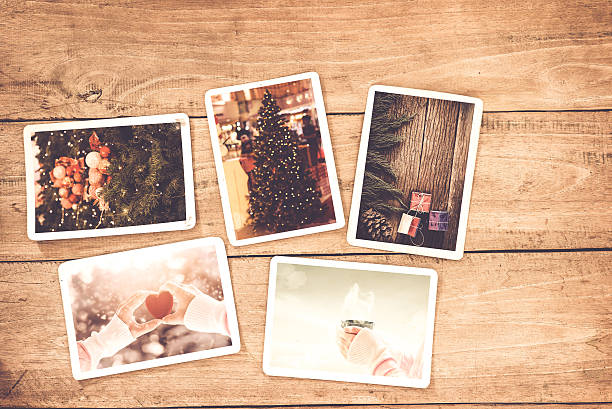 Christmas photo Merry christmas (xmas) photo album on old wood table. paper photo of polaroid camera - vintage and retro style pinaceae photos stock pictures, royalty-free photos & images