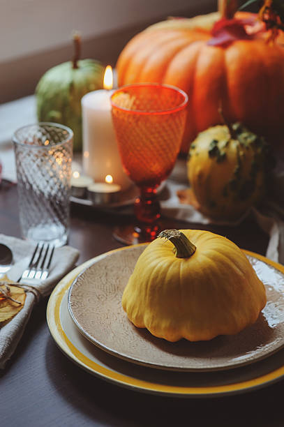 istock autumn traditional table setting for Thanksgiving or Halloween 607898410