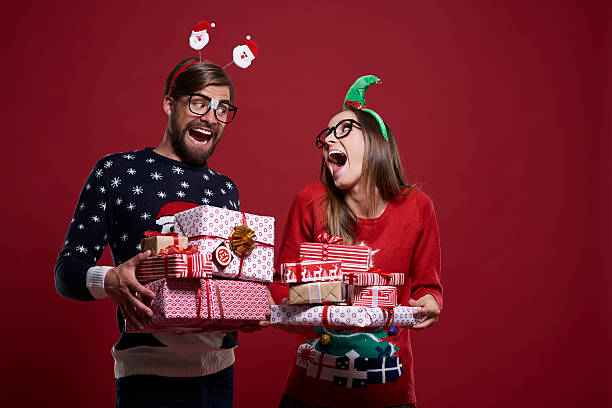 istock Funny Christmas nerds with presents 607899010