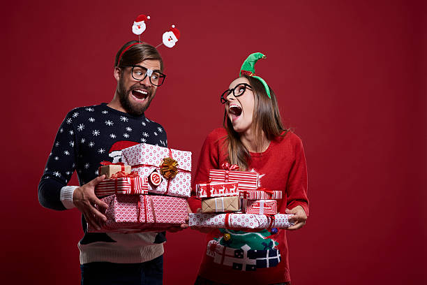 Funny Christmas nerds with presents Funny Christmas nerds with presents christmas nerd sweater cardigan stock pictures, royalty-free photos & images
