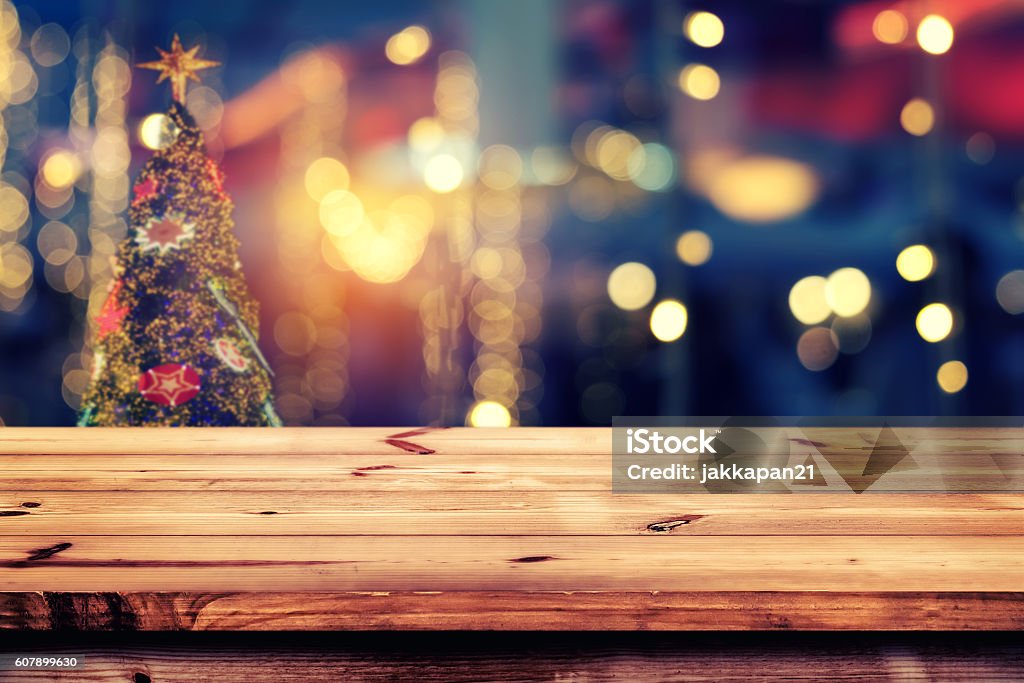 Christmas background Top of wood table with christmas abstract background light bokeh from Xmas tree at night party in winter - Empty ready for your product display or montage. vintage color tone Christmas Stock Photo