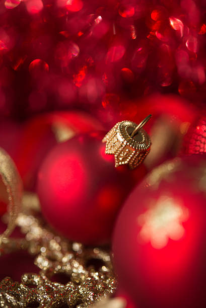 istock Red and golden xmas ornaments on bright bokeh background 607900164