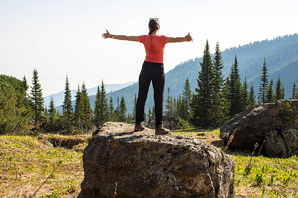 istock girl celebrates victory in the mountains 607902010