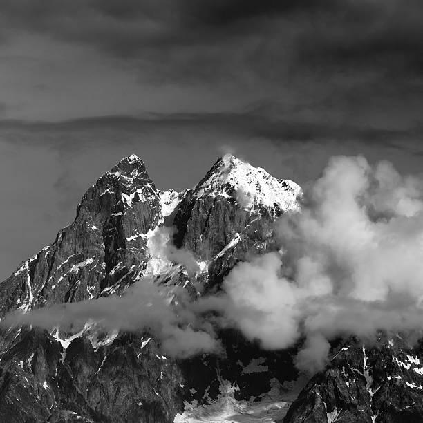istock Black and white view on Mt. Ushba in clouds 607903482