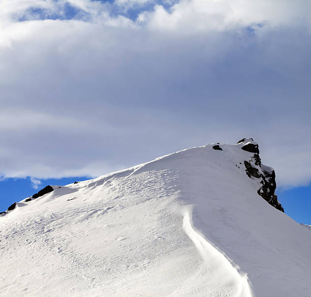 istock Top of mountains with snow cornice after snowfall 607903590