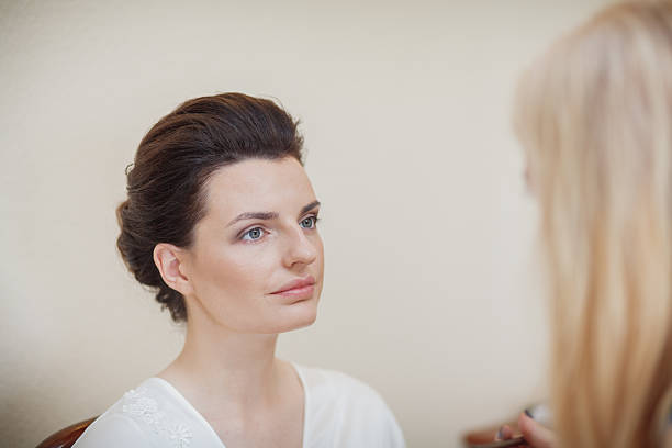 istock makeup preparing bride before the wedding in a morning 607904728
