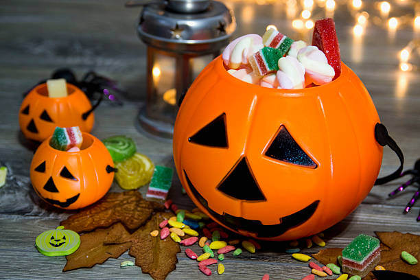 istock Halloween pumpkin head jack lantern on wooden background 607905280