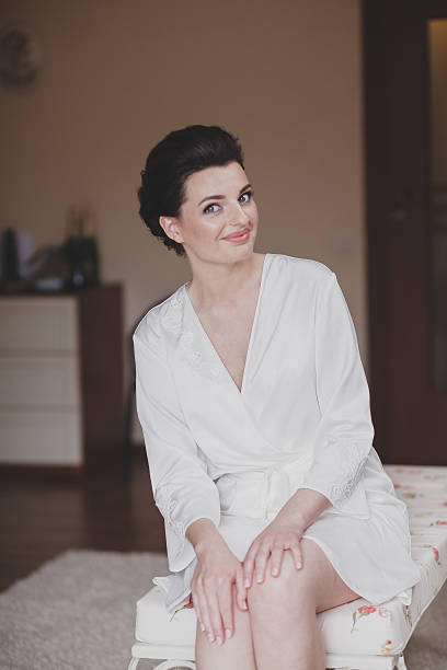 istock woman wearing bathrobe at hotel room 607906204