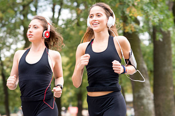 istock Two beautiful young female joggers training for a marathon 607906510