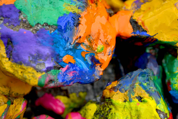 stones with colorful paint. Abstract background colored stones randomly in different colors