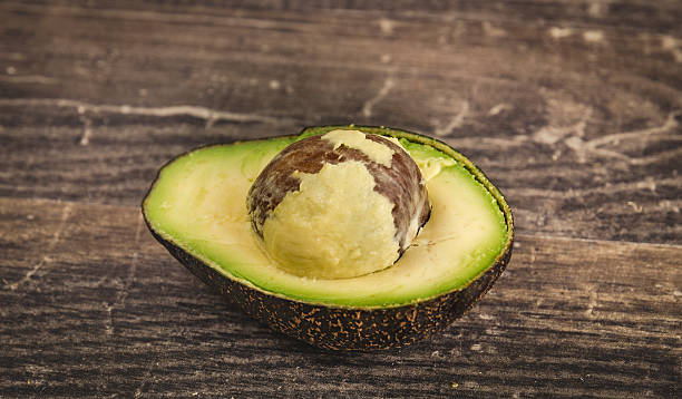 istock Single half of a delicious avocado 607907110