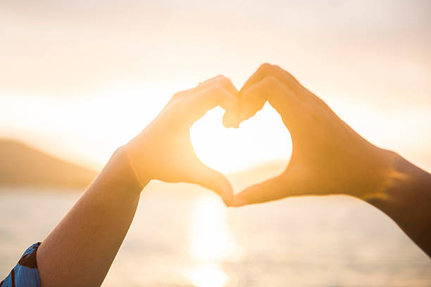 istock couple made heart symbol by hand 607907378