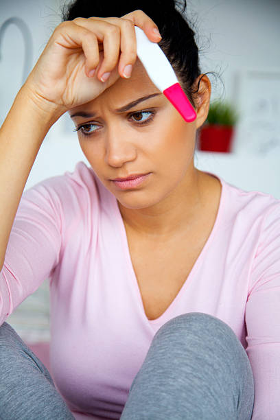 istock worried young woman with pregnancy test 607913946