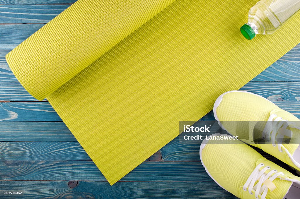 Healthy lifestyle background. Sport equipment Healthy lifestyle background. Yoga mat, sport shoes, bottle of water on wooden background. Concept healthy and sport life. Top view Equipment Stock Photo