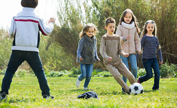 istock children running after ball 607914594