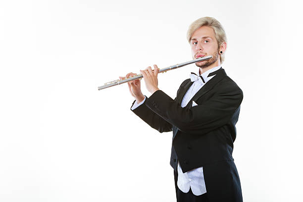 istock Male flutist wearing tailcoat plays flute 607914962